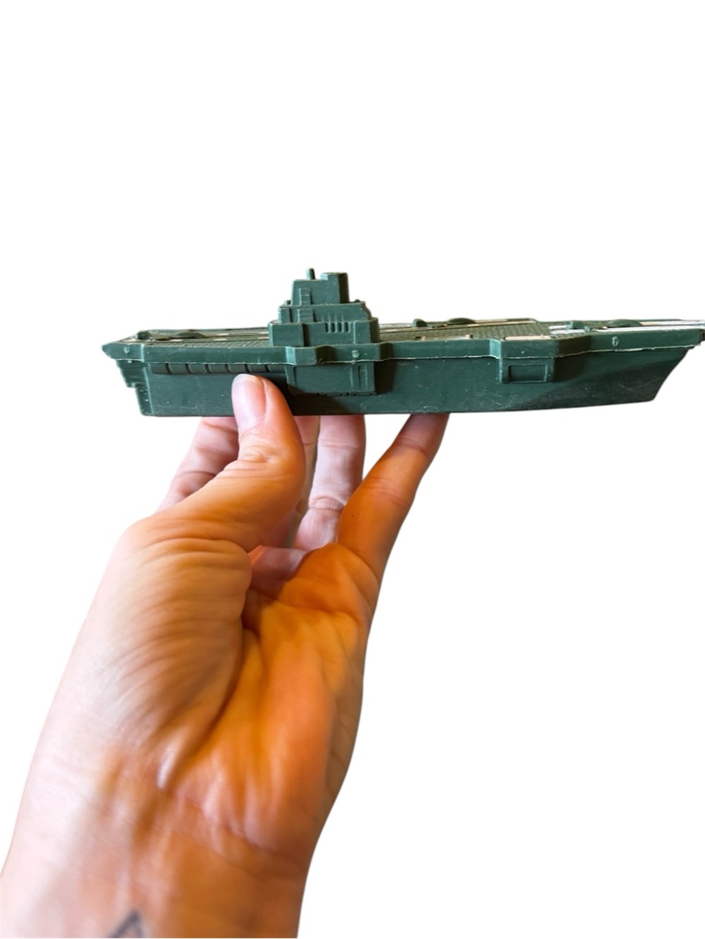 small green plastic toy aircraft carrier